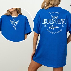 Blue t-shirt with "Broken Heart Legion" design on back, and angel graphic inset.
