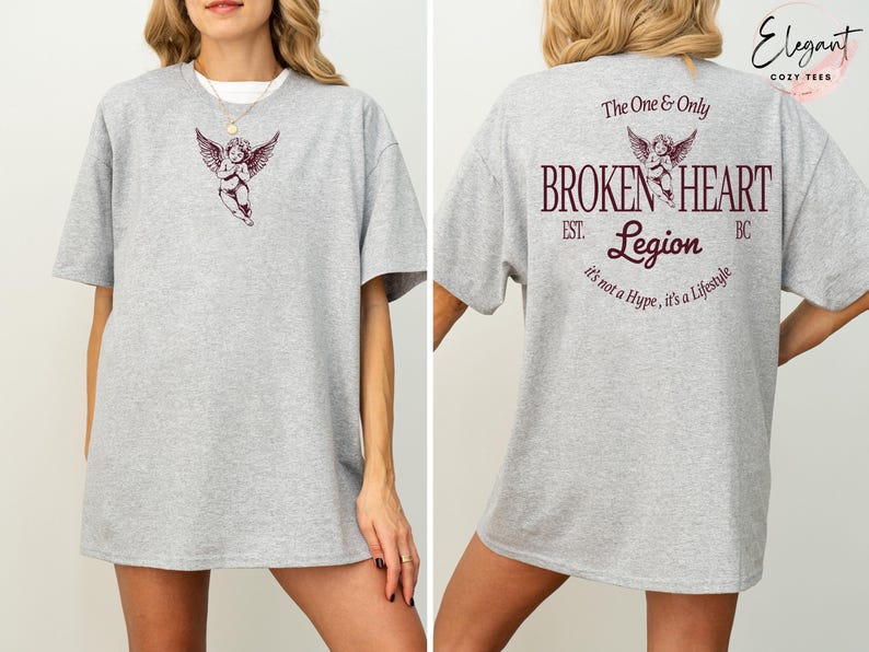 Grey t-shirt with cupid graphic and "Broken Heart Legion" text on back.