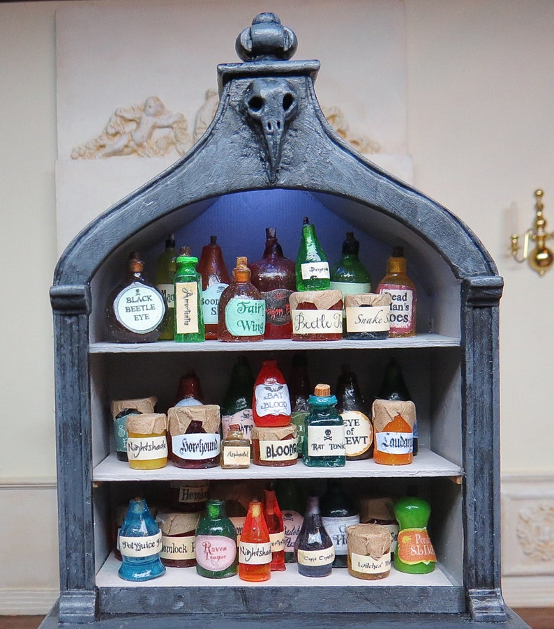 May include: A dark wooden shelf with a gothic archway design, filled with glass bottles and jars containing various potions and ingredients. The labels on the bottles and jars include names like "Black Beetle Eye", "Amortentia", "Fair Wine", "Bat Blood", "Eye of Newt", and "Laudanum".