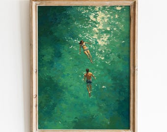 May include: A framed art print depicts two figures swimming in turquoise water. The artwork, with a textured, painterly style, features a woman in a bikini and a man in swim trunks. The print is framed in a light-colored wooden frame. The text "DIGITAL ART CREATIV" is at the top.