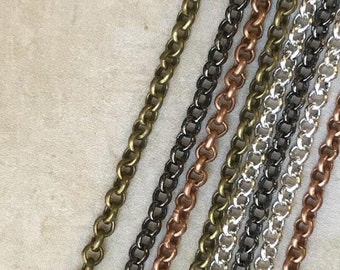 May include: Five different chain styles in various metal finishes, including copper, silver, and gold. The chains are arranged in a row and are all the same length.