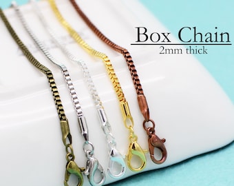 May include: Four different colored box chains with lobster clasps. The chains are 2mm thick and are shown on a white surface.  Box Chain 2mm thick.