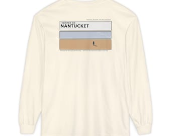 May include: Cream-colored long-sleeve shirt with a graphic on the back. The graphic features the text "I WINTER ON NANTUCKET" above a rectangular design with a person on a beach. The text "THE STILL SEASON. THE REAL SEASON" is above the graphic.