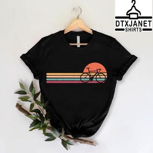 a black shirt with a bicycle on the front of it