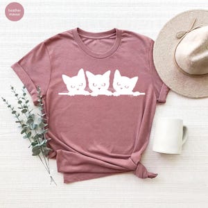 a t - shirt with three cats on it