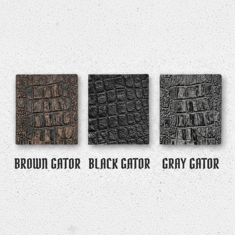 May include: Three square swatches featuring a textured alligator skin pattern in brown, black, and gray. Each swatch is labeled below with the text BROWN GATOR, BLACK GATOR, and GRAY GATOR, respectively, indicating the color of each sample.
