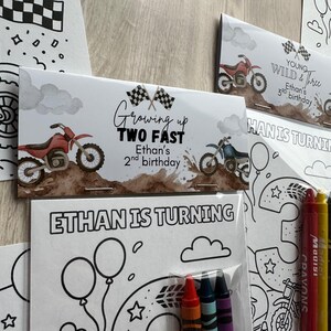 May include: Party favour sets with a motocross theme. The design includes the text "Growing up TWO FAST" and "Ethan's 2nd birthday" on a card with a red dirt bike illustration. Other cards say "Ethan is turning" and "Young, Wild & Three".