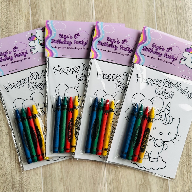 May include: Four party favours with colouring pages and crayons. Each favour includes a white colouring page with the text "Happy Birthday Gigi!" and a set of six crayons in red, yellow, green, blue. The favours are packaged in clear plastic with a purple topper that reads "Gigi's 6th Birthday Party!"