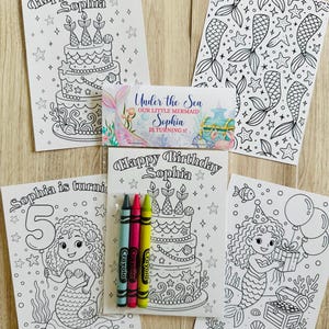 May include: A collection of mermaid-themed coloring pages and a small card. The coloring pages feature birthday cakes, mermaids, and the text "Happy Birthday Sophia". The small card reads "Under the Sea Our Little Mermaid Sophia is turning 5!" and includes crayons.