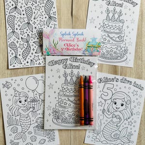 May include: A set of mermaid-themed coloring pages and crayons. The pages feature mermaids, birthday cakes, and the text "Happy Birthday Alice!" and "Alice's 5th Birthday!" The crayons are orange, purple, and pink.