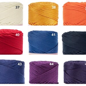 May include: Nine spools of coloured cord in shades of cream, gold, orange, red, blue, navy, dark blue, purple, and dark purple. Each spool is labelled with a number from 37 to 45.
