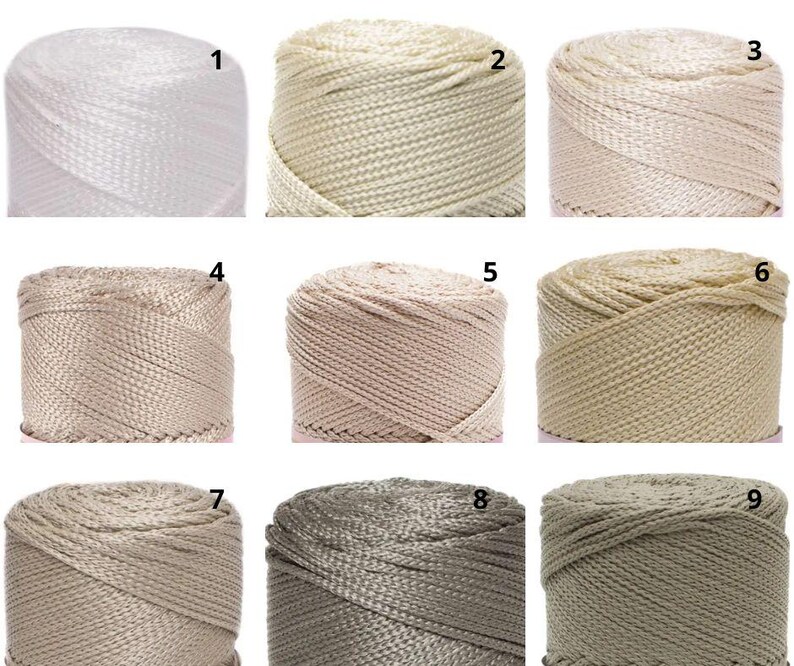 May include: Nine spools of nylon cord in a range of neutral shades. The spools are numbered 1 to 9, with colours from white to beige, tan, and grey. The cord has a woven texture, suitable for crafting and macram&eacute; projects.