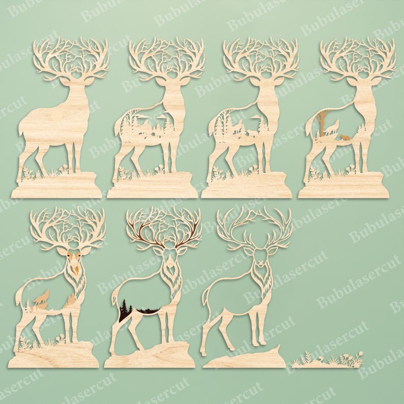 May include: A collection of seven light-colored wooden deer silhouettes featuring intricate laser-cut designs. Each deer displays detailed antlers and various cut-out forest scenes, including mountains, trees, and wildlife, with one deer left blank.