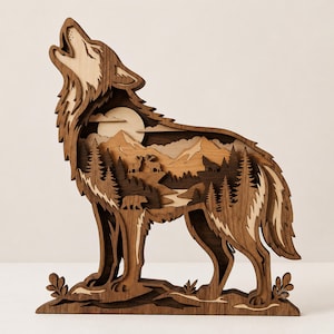 May include: A multi-layered wooden wall art piece shaped like a howling wolf. The interior cutout features a detailed forest landscape with mountains, pine trees, a bear, deer, and a full moon, rendered in varying shades of natural brown wood tones.