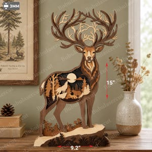 May include: A multi-layered wooden deer sculpture featuring a cutout forest scene with a wolf and bear silhouette against a moon. The deer stands on a base, measuring 38.1 cm in height and 23.37 cm in width, crafted from 3mm thick wood panels.