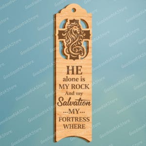 May include: Wooden bookmark with a lion and cross design. The bookmark has the text "HE alone is MY ROCK And my Salvation ...MY... FORTRESS WHERE". The bookmark has a hole at the top for a tassel.