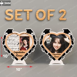 May include: Set of two wooden heart-shaped picture frames with black graduation caps and diplomas around the edges. Each frame has a 4x6 inch photo opening and a white stand. The frames are decorated with the text "Class of 2025" and "Congratulations, Emma!"