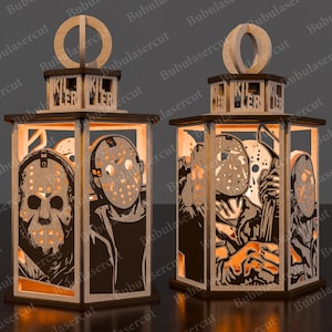 May include: Two wooden lanterns with a horror theme. Each lantern features a rectangular frame with cut-out images of a masked killer. The word "KILLER" is cut out at the top. The lanterns are made of light-colored wood with dark brown accents.