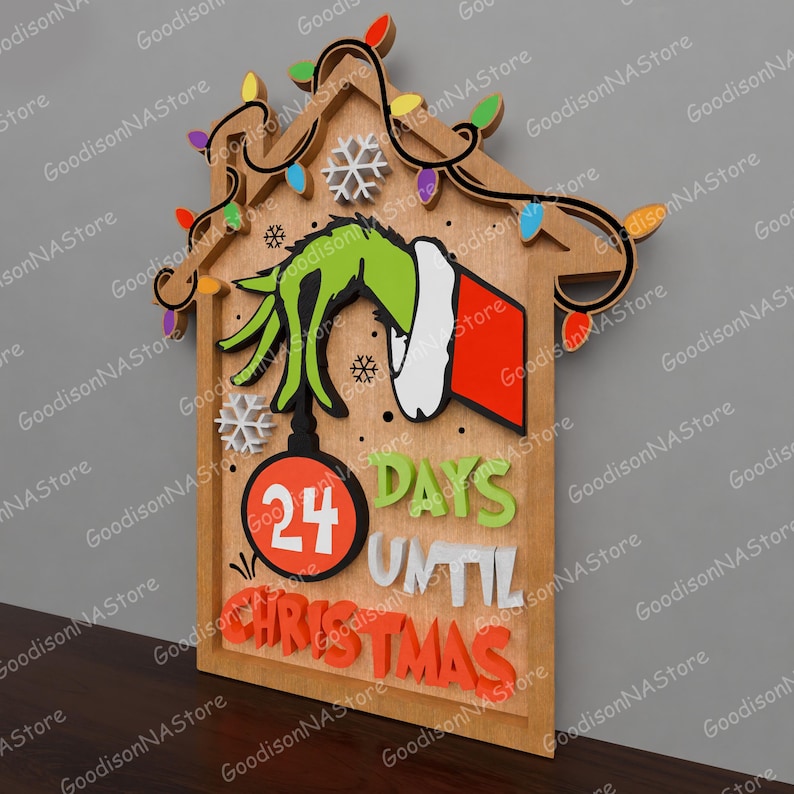 May include: Wooden Christmas countdown sign featuring a Grinch hand holding a Christmas ornament. The sign reads "24 Days Until Christmas" in colorful 3D letters. Decorative lights and snowflakes adorn the top of the sign.