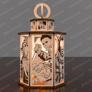 May include: A wooden Halloween-themed lantern featuring laser-cut images of horror movie characters. The lantern has a hexagonal base and top, with the word "KILLER" cut into the top. The images include a knife-wielding figure and a clown.