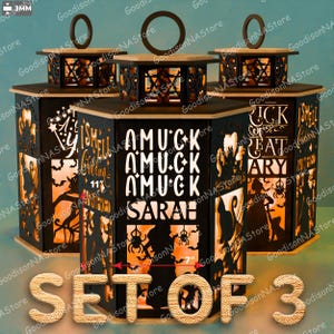 May include: Set of 3 Halloween-themed lanterns. Each lantern is black with laser-cut designs and text, including "I Smell Children", "Amuck Amuck Amuck Sarah", and "Trick or Treat". The lanterns are 7 inches wide and have a wooden top with a circular handle.