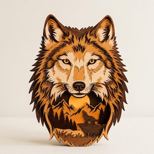 May include: A multi-layered wooden wall art piece shaped like a wolf head. The design features a detailed wolf face with shades of brown and tan, and a cutout section at the bottom showing a silhouette of a wolf howling at a yellow sun over mountains.
