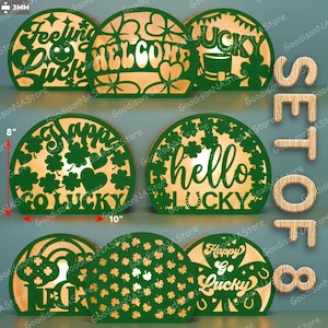Puede incluir: Un conjunto de ocho decoraciones luminosas LED semicirculares verdes y doradas con temática del Día de San Patricio. Cada pieza presenta diseños recortados con frases como "Feeling Lucky" y "Welcome", y mide 25 cm de ancho y 20 cm de alto.