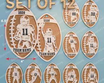 May include: Set of 12 football-shaped ornaments. Each ornament is approximately 4 inches wide and 6.5 inches tall. The ornaments feature a football player design with the year 2026 and space for a team name. Made of light brown material.