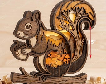 May include: A multi-layered wooden squirrel sculpture featuring a forest scene with a tree, deer, and mushrooms. The piece is 15 inches tall and 15 inches wide, constructed from 3mm thick wood with a warm internal light glow.
