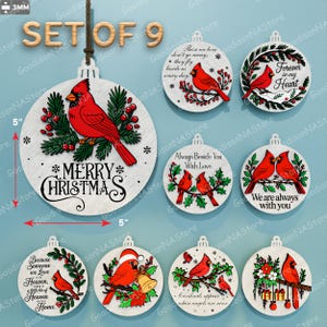 May include: Set of nine Christmas ornaments. Each ornament is a white circle with a red cardinal bird design. The ornaments have various phrases, including "Merry Christmas" and "Forever in my Heart." Each ornament is 5 inches in diameter.