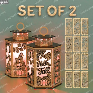 May include: Set of two wooden lanterns with intricate laser-cut designs featuring pumpkins, leaves, and the text "Hello Fall." Each lantern has a handle and a light inside. Additional decorative panels are included.