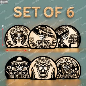 May include: A set of six Day of the Dead decorations. Each decoration is a half-circle shape, approximately 20 cm tall and 25 cm wide, featuring intricate laser-cut designs of sugar skulls and figures. The text "SET OF 6" is at the top.