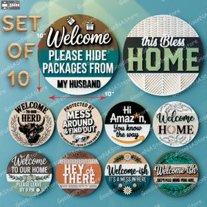 May include: A set of 10 round wooden signs with various welcome messages. The largest sign is 10 inches in diameter and says "Welcome, Please Hide Packages From My Husband." Other signs include humorous phrases and decorative elements.