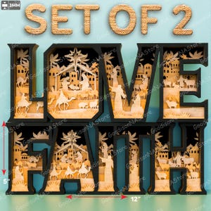 May include: A set of two wooden wall art pieces spelling out "LOVE FAITH". Each black-framed letter features a detailed, layered nativity scene in light wood. The set is approximately 12 inches wide and 5 inches tall.