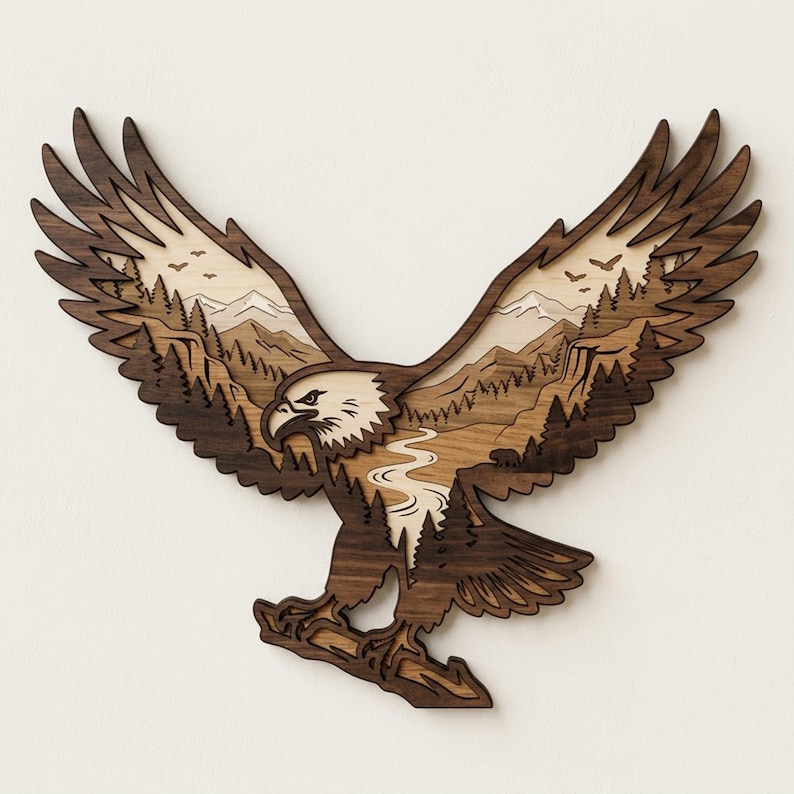 May include: A multi-layered wooden wall art piece shaped like a soaring eagle. The design features a dark brown wood silhouette of an eagle with a cutout center revealing a light-colored wood landscape of mountains, a winding river, and pine trees.