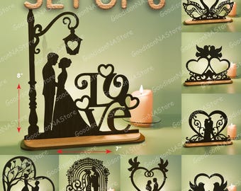 Könnte beinhalten: Set aus 8 Holzdekorationen für Hochzeiten. Das Set enthält Silhouetten von Paaren, Schwänen und Herzen. Das größte Stück ist 20 cm hoch und 18 cm breit. Ein Design zeigt das Wort "LOVE".