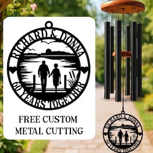 May include: Black metal wind chimes with a wooden top and a decorative metal pendant. The pendant features a silhouette of a couple walking, with the text "RICHARD & DONNA 60 YEARS TOGETHER".