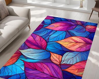 May include: Abstract rug with a colorful design of overlapping leaves in shades of blue, pink, purple, and orange.