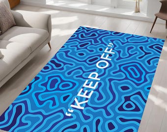May include: Blue and white rug with a wavy pattern and the text "KEEP OFF" in white.