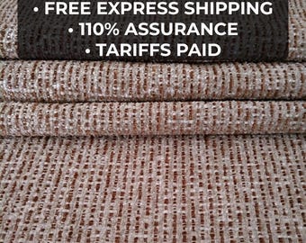 May include: Close-up of textured fabric in shades of brown and beige. The fabric is tightly woven with a subtle pattern. Text at the top reads "ANY COMBO - MIN 3 YARDS", "FREE EXPRESS SHIPPING", "110% ASSURANCE", and "TARIFFS PAID". The bottom text says "13 COLORS".