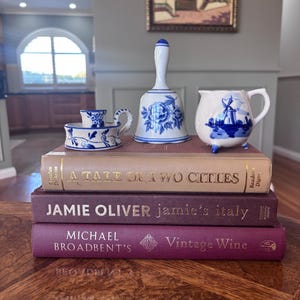 May include: A set of three ceramic mugs with a speckled, matte finish in cream, light grey, and dark grey. Each mug has a simple, minimalist design, ideal for tea or coffee.