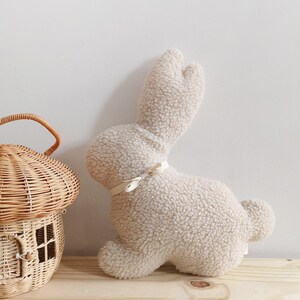 Easter bunny pillow used as spring decor, plush rabbit cushion for Easter home accents