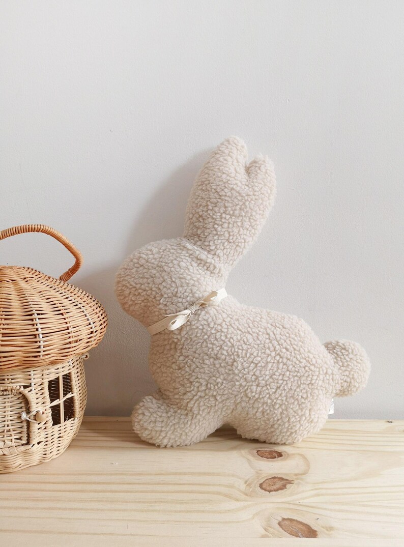 Easter bunny pillow used as spring decor, plush rabbit cushion for Easter home accents