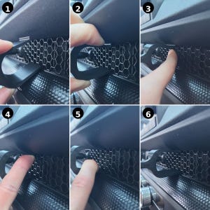 May include: A black, U-shaped plastic clip designed for installation into a vehicle's dashboard air vent. The clip features a curved hook end that inserts into the hexagonal honeycomb grille pattern of the vent, securing it firmly in place.