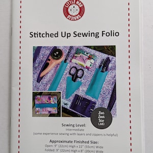 May include: A white booklet titled "Stitched Up Sewing Folio" with a red dashed border. The cover features a sewing-themed design with tools and a finished folio. Approximate finished sizes are 9" x 22" open and 9" x 8" folded.