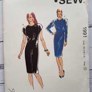 May include: A vintage Kwik Sew sewing pattern envelope, pattern number 1991. The cover shows illustrations of two dresses, one black and one blue. Sizes available are XS, S, M, L, and XL. Designed by Kerstin Martensson.