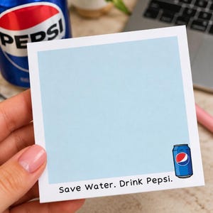 May include: A square light blue sticky note featuring a small illustration of a blue Pepsi soda can in the bottom right corner and the black printed text Save Water. Drink Pepsi. at the bottom edge of the white border frame.