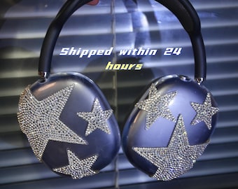 May include: A pair of silver headphones with a star-shaped design made of rhinestones. The headphones are over-ear and have a black headband.