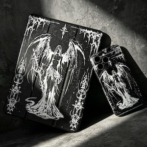 May include: A black tablet case and a matching smartphone case, both featuring a white graphic illustration of a winged figure with long hair, surrounded by intricate, sharp-edged decorative patterns and a star symbol at the top center.