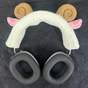 Peut inclure: Bandeau en crochet blanc avec des oreilles d'agneau brunes et roses. Le bandeau est con&ccedil;u pour s'adapter sur des &eacute;couteurs.